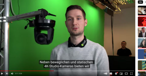 Video-Screenshot zeigt Sprecher und Untertitel.